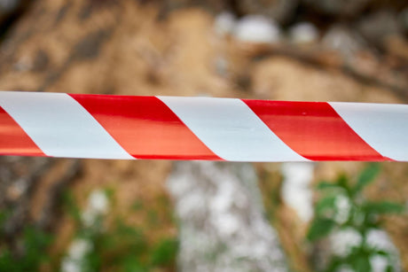 Red and white barrier warning tape sign