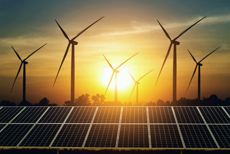 Solar panel and turbine with sunset background