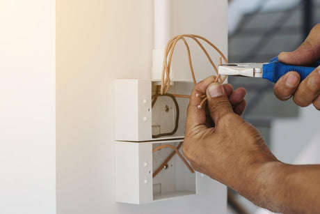 electrician installing a plastic surface box 