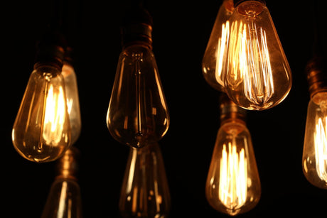 Close-up of illuminated light bulbs against black background