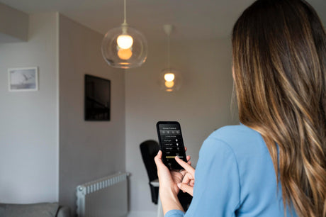 woman turning on lights with smart plugs 