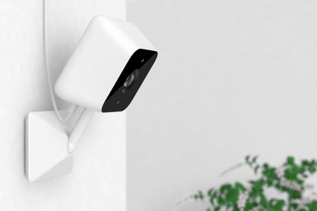 White Modern Web Camera on a White Room Wall 