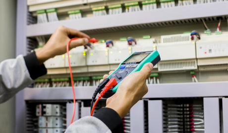 Technicians inspect electrical control cabinets