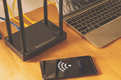 Flat lay Office table with wifi router, computer and supplies top view