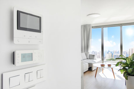Modern air conditioning control intercom display switches on white wall in cozy light apartment free space