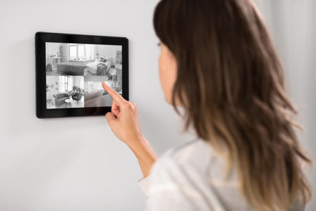 Woman having video control from tablet pc at home