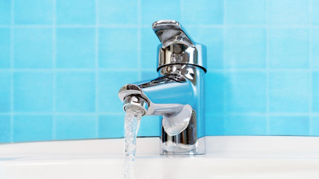 Close-up of faucet in bathroom