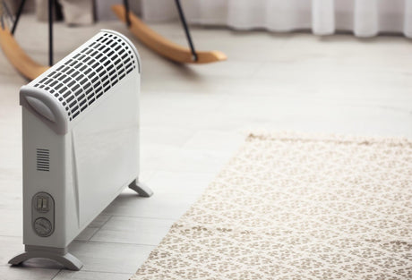 Modern electric heater in stylish room interior 