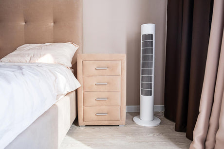 Modern bedroom with sleek tower fan and beige nightstand