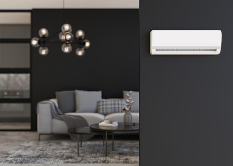 Modern air conditioner hanging on the wall in room