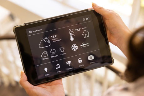 Using tablet to control smart home system adjusting temperature and settings