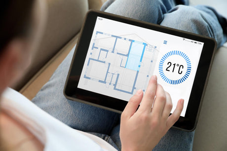 Woman using tablet to control office heating system