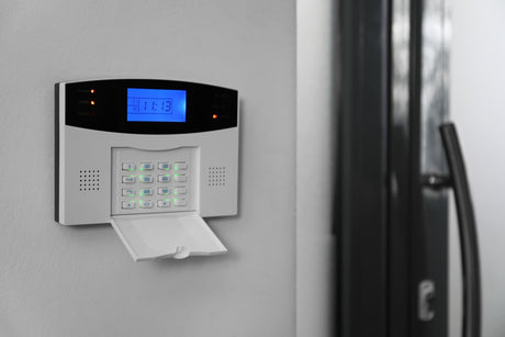Home security system on white wall indoors