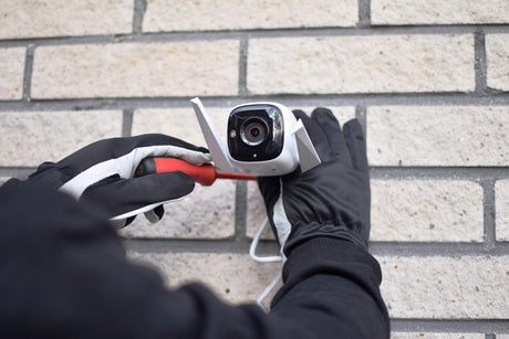 Person installs a surveillance camera