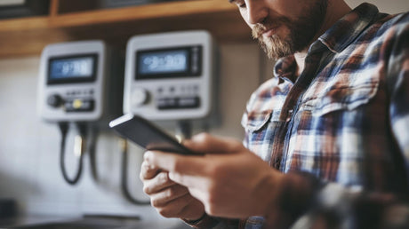 man using smart phone by smart meter 