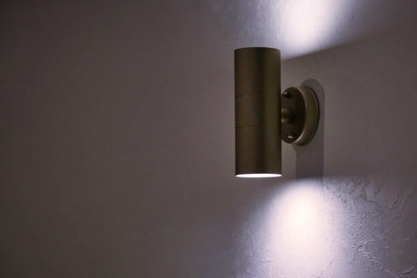 Stylish modern lamp on white textured vintage wall 