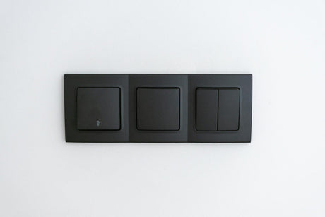 White wall with several switches to turn the black light on and off