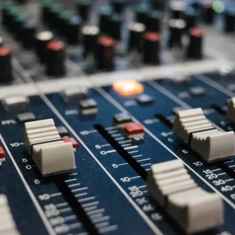 close up of audio desk with switches and buttons 